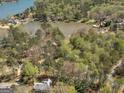 Aerial view of a lakefront community with mature trees and several homes on the shores of the lake at 2270 Emerald Dr, Jonesboro, GA 30236