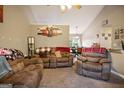 Comfortable living room with plush, oversized seating and an open view into the dining area at 8915 Tweeddale Dr, Winston, GA 30187