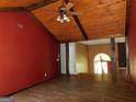 Living room with wood flooring, beamed ceiling, and open layout to the kitchen at 1306 Stonemont Rd, Auburn, GA 30011