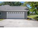 Attached two-car garage featuring a clean white door and grey painted walls at 2303 Sharon Se Ct, Conyers, GA 30013