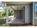Cozy covered patio with sliding glass door and exterior light at 2303 Sharon Se Ct, Conyers, GA 30013