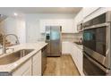 Modern kitchen with stainless steel appliances, granite countertops, and white cabinetry at 1225 Hibiscus Way, Mcdonough, GA 30253