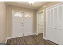 Inviting foyer featuring new flooring, a double-door entry, and a convenient coat closet at 105 Lake Forest Dr, Peachtree City, GA 30269