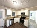 Modern kitchen featuring white cabinets, stainless steel appliances, and granite countertops at 2239 Nelms Sw Dr, Atlanta, GA 30315