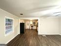 Open-concept living room with hardwood floors and view of the kitchen at 2239 Nelms Sw Dr, Atlanta, GA 30315