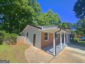Brick and siding exterior with a covered porch supported by decorative columns at 1150 Goldsmith Rd, Stone Mountain, GA 30083