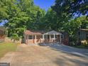 Charming brick home featuring a covered front porch and ample concrete driveway at 1150 Goldsmith Rd, Stone Mountain, GA 30083