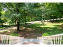 A view from the porch of the property's front yard, showcasing mature trees, and a long driveway at 1655 Stacia Dr, Covington, GA 30016