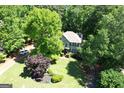 Aerial view of a home surrounded by lush greenery, showcasing its well-kept lawn and classic architectural design at 350 Ridgemont Dr, Fayetteville, GA 30215