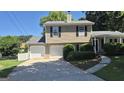 Inviting two-story home with a two-car garage, landscaped yard, and a classic design on a sunny day at 6120 Raleigh Oaks Ct, Lithonia, GA 30058