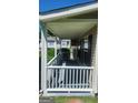 Charming covered porch with white railings, offering a relaxing outdoor space with great natural lighting at 6120 Raleigh Oaks Ct, Lithonia, GA 30058