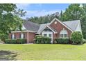 Beautiful brick home with a well-manicured lawn and garden at 1108 The By Way, Mcdonough, GA 30252