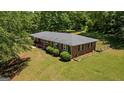 A charming brick home with a well-maintained lawn and surrounding greenery, capturing its inviting curb appeal at 416 S Carroll Rd, Villa Rica, GA 30180