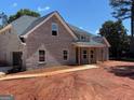 Angle view of new construction featuring a gray brick exterior and two car side entry garage at 1705 Lake Dow Rd, Mcdonough, GA 30252