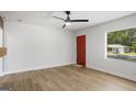 Bright, spacious bedroom with modern ceiling fan, large windows, and sleek flooring at 5180 Ash St, Forest Park, GA 30297