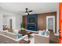 Beautifully staged living room features modern fireplace, wood paneling, and stylish furniture at 5180 Ash St, Forest Park, GA 30297
