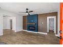 Bright living room with a ceiling fan and fireplace, and a doorway to a bathroom at 5180 Ash St, Forest Park, GA 30297