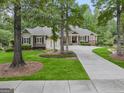 Beautiful home with lush landscaping, a circular driveway, and mature trees at 115 Edgewood Pkwy, Fayetteville, GA 30215