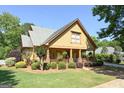 Inviting craftsman style home with a well-maintained lawn and a cozy covered front porch at 3007 Brush Arbor Xing, Mcdonough, GA 30252