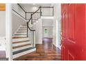 Inviting foyer with hardwood floors, staircase, and glass-paneled door leading to another room at 220 Drumcliff Ct, Tyrone, GA 30290