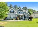 Charming two-story home with fresh landscaping and a well maintained lawn at 130 Edgewater Trl, Fayetteville, GA 30215