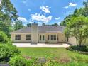 Rear view of a one story home with a large patio and plenty of yard at 264 Keller Dr, Mcdonough, GA 30252