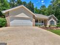 Traditional home with a driveway leading to an attached two car garage at 264 Keller Dr, Mcdonough, GA 30252