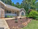 This home has a beautiful front garden and a cute porch at 264 Keller Dr, Mcdonough, GA 30252