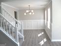 Well-lit dining room with modern light fixture, wainscoting and multiple windows at 7564 Mountain Ridge Ln, Lithonia, GA 30058