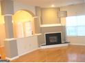 Bright living room featuring a fireplace and architectural columns, accentuated by natural light at 4000 Orchard Hill Ter, Stone Mountain, GA 30083