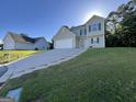 Traditional two-story home featuring a large driveway, green shutters, and well-manicured lawn at 5627 Isleworth Ct, Atlanta, GA 30349