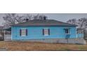 Side view of charming blue home with dark shutters and window on the side at 1730 Spring Ne St, Conyers, GA 30012