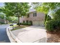 Spacious two-car garage with a long driveway and mature landscaping at 3519 Preserve Se Dr, Atlanta, GA 30339