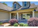 Close up of the front of a single-Gathering home showcasing the stone accents and manicured bushes at 70 Country Meadows Ln, Covington, GA 30014