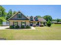Beautiful single-Gathering home featuring a large, well-maintained lawn and lovely shrubbery at 70 Country Meadows Ln, Covington, GA 30014
