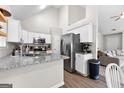 Modern kitchen featuring granite countertops, stainless steel appliances, and stylish white cabinetry at 75 Mcintosh Estates Ct, Sharpsburg, GA 30277