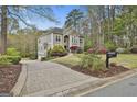 Well-maintained house with a long driveway, three-car garage and lush landscaping at 1000 Pleasance Grv, Peachtree City, GA 30269