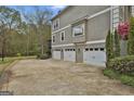 Attached three car garage with ample parking and a long driveway at 1000 Pleasance Grv, Peachtree City, GA 30269