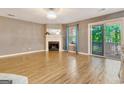 Inviting living room with fireplace, hardwood floors and a view of the balcony at 606 Ridgelake Dr, Peachtree City, GA 30269