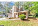 Charming two-story home with a unique turret and an attached two-car garage nestled among mature trees at 916 Forest Pointe, Jonesboro, GA 30238