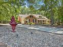 Beautifully landscaped home featuring a circular driveway and mature trees at 401 Riverwalk, Mcdonough, GA 30252