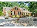 Lovely brick home with manicured lawn and blooming flowerbeds at 401 Riverwalk, Mcdonough, GA 30252