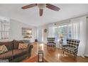 Bright living room with hardwood floors, two club chairs, and large windows providing natural light at 2006 Carrollton Hwy, Temple, GA 30179