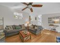 Comfortable living room featuring hardwood floors, cozy seating, and stairway to the basement at 2006 Carrollton Hwy, Temple, GA 30179