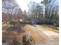 Single-story home with carport and long driveway, seen from above at 4884 Maurice Nw Dr, Lilburn, GA 30047