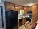 Functional kitchen with ample wood cabinetry, modern black appliances, and a convenient layout at 4884 Maurice Nw Dr, Lilburn, GA 30047
