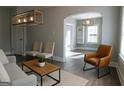 Bright living room features stylish light fixture, neutral paint, and archway entrance at 2134 Main Nw St, Atlanta, GA 30318