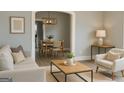 Cozy living room with modern furnishings, neutral tones, and an inviting open concept layout to the dining area at 2134 Main Nw St, Atlanta, GA 30318