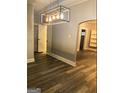 Open living area with updated lighting, hardwood floors, built-in shelving, and neutral gray paint at 2134 Main Nw St, Atlanta, GA 30318