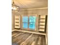 Living room featuring wood-look flooring, built in shelving, and double-paned windows for natural light at 2134 Main Nw St, Atlanta, GA 30318